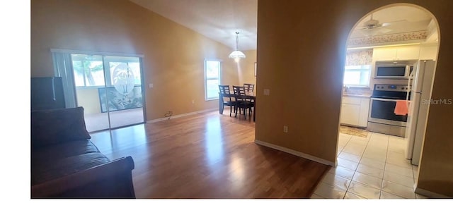 4432 Whitton Way, New Port Richey, FL 34653 - hallway with lofted ceiling, light wood-style floors, and arched walkways