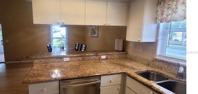 4432 Whitton Way, New Port Richey, FL 34653 - kitchen with dishwasher, a peninsula, healthy amount of natural light, and white cabinets