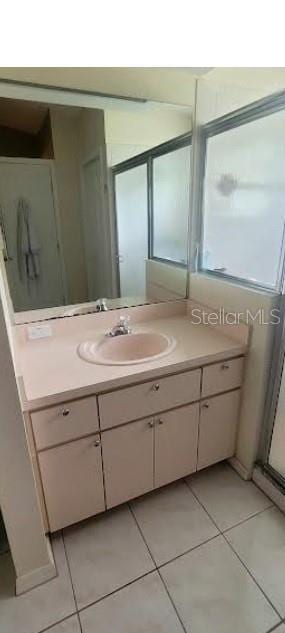 4432 Whitton Way, New Port Richey, FL 34653 - bathroom with vanity, tile patterned floors, and a shower with shower door