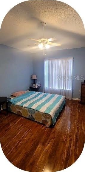 4432 Whitton Way, New Port Richey, FL 34653 - bedroom with wood finished floors, ceiling fan, and a textured ceiling