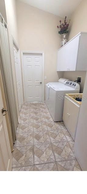 4432 Whitton Way, New Port Richey, FL 34653 - laundry room with cabinet space and separate washer and dryer
