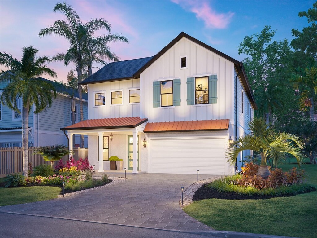1821 Maryland Ave NE, Saint Petersburg, FL 33703 - modern farmhouse with board and batten siding, fence, covered porch, driveway, and an attached garage
