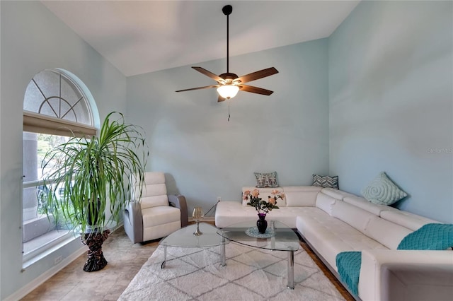 living room with light hardwood / wood-style floors, vaulted ceiling, and ceiling fan