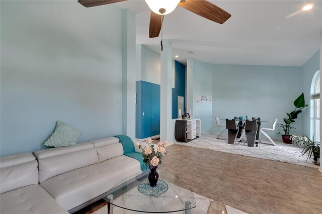 carpeted living room featuring lofted ceiling and ceiling fan