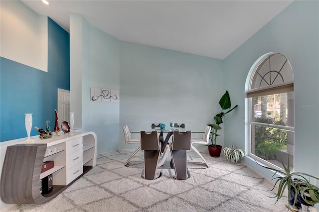 office featuring light carpet and high vaulted ceiling