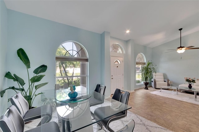 dining area with vaulted ceiling, ceiling fan, and plenty of natural light