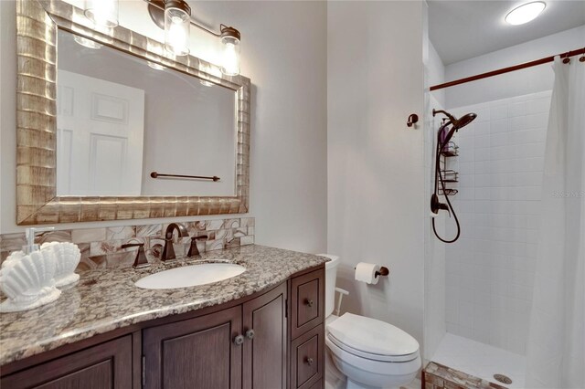 bathroom featuring a shower with curtain, vanity, backsplash, and toilet