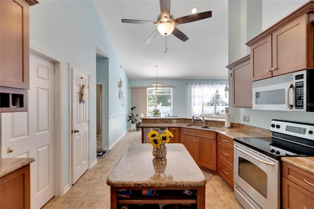 kitchen featuring sink, stainless steel range with electric cooktop, ceiling fan with notable chandelier, light tile patterned floors, and decorative light fixtures