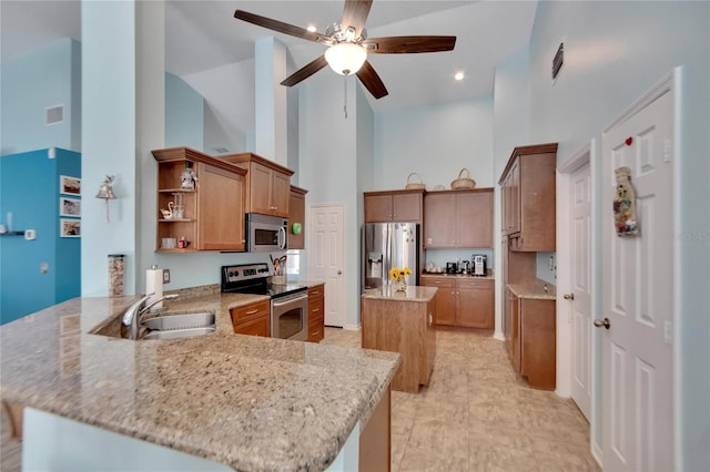 kitchen featuring appliances with stainless steel finishes, kitchen peninsula, light stone countertops, and high vaulted ceiling