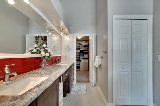 bathroom featuring vanity, tasteful backsplash, and tile patterned floors