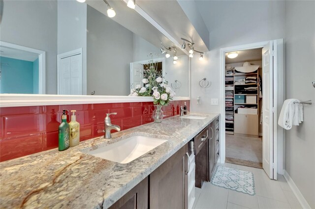 bathroom with vanity, tile patterned floors, a high ceiling, and decorative backsplash