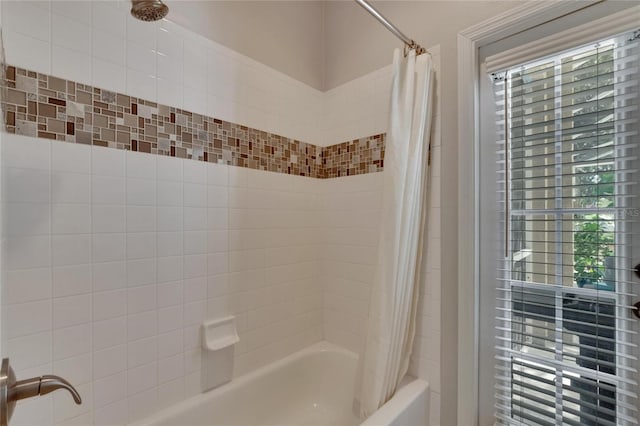 bathroom with shower / bathtub combination with curtain