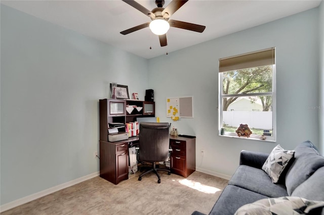 carpeted office featuring ceiling fan