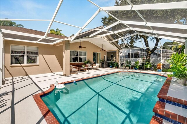 view of swimming pool with a lanai, a patio, and ceiling fan