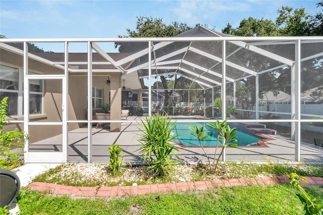 view of swimming pool featuring glass enclosure and a patio area