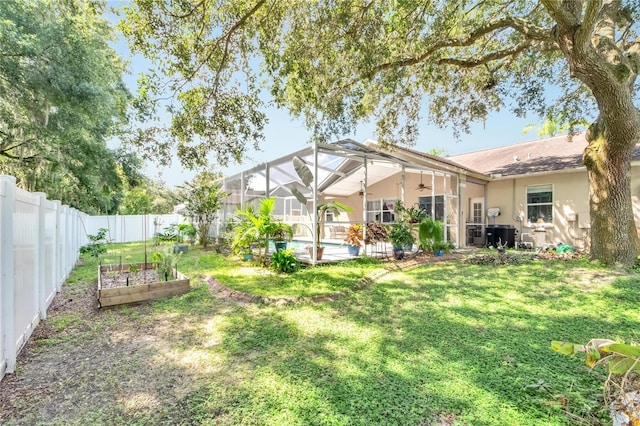 view of yard with a lanai and a fenced in pool