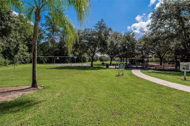 surrounding community with a gazebo, a lawn, and volleyball court