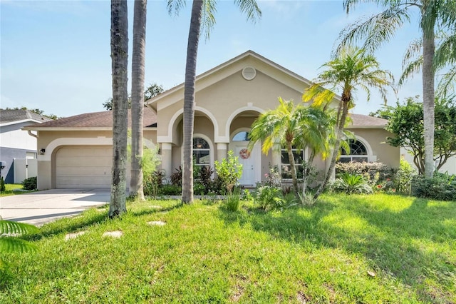 mediterranean / spanish house featuring a garage and a front yard