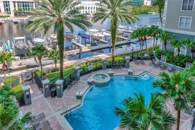 view of pool with a patio and a water view