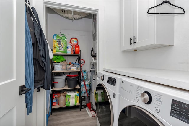 clothes washing area with light hardwood / wood-style floors, independent washer and dryer, and cabinets