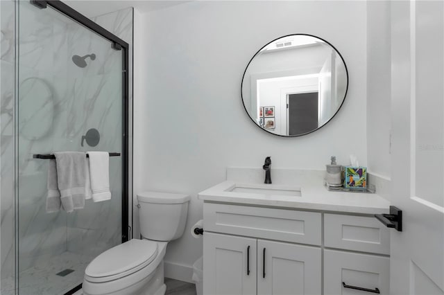 bathroom with a shower with door, vanity, and toilet