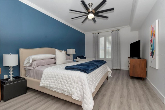 bedroom featuring ornamental molding, light hardwood / wood-style floors, and ceiling fan