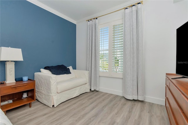 sitting room with crown molding, light hardwood / wood-style flooring, and a wealth of natural light