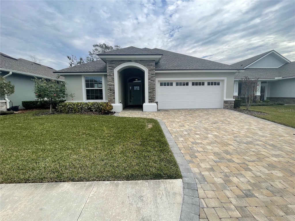 view of front facade featuring a front lawn and a garage