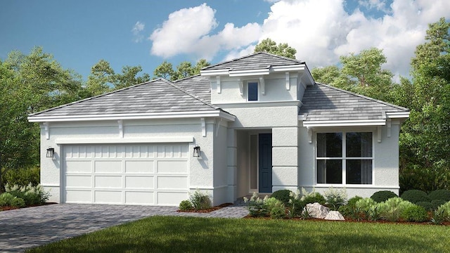 view of property with a garage and a front lawn