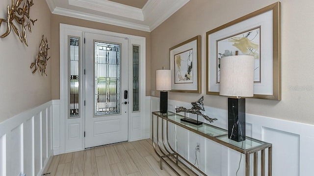 foyer featuring crown molding