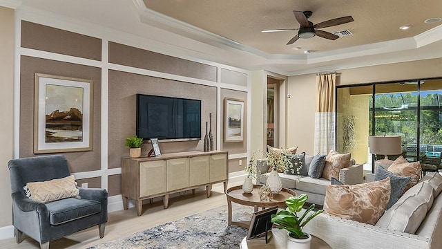 sunroom / solarium featuring ceiling fan and a tray ceiling