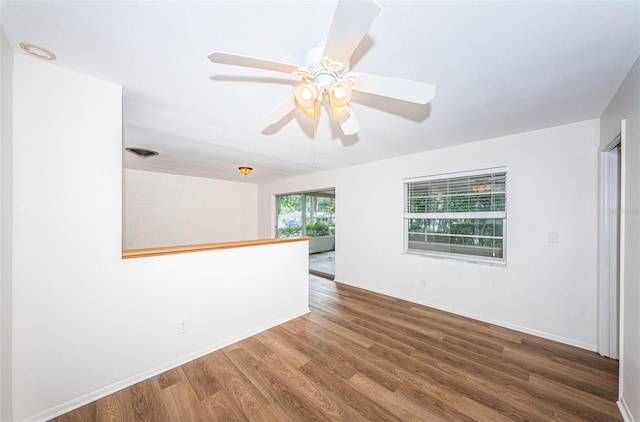 empty room with ceiling fan and hardwood / wood-style flooring