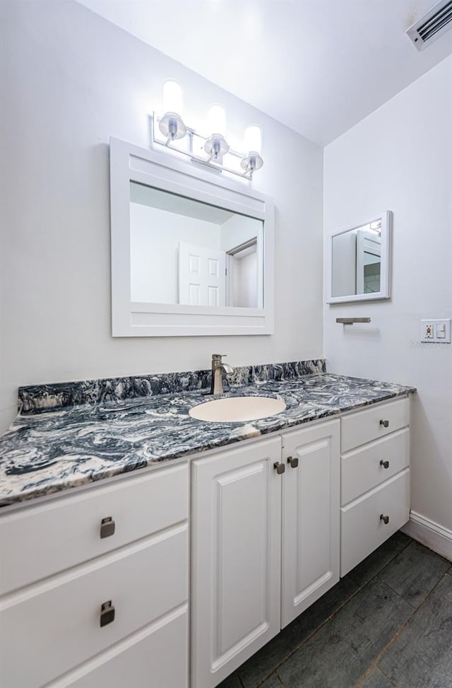 bathroom featuring vanity and hardwood / wood-style floors