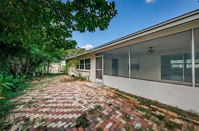 view of yard with ceiling fan and a patio