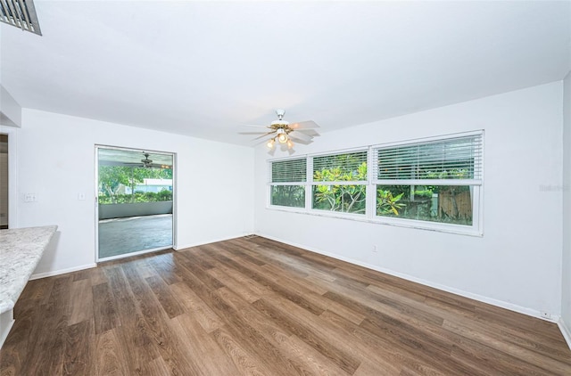 spare room featuring wood-type flooring and ceiling fan