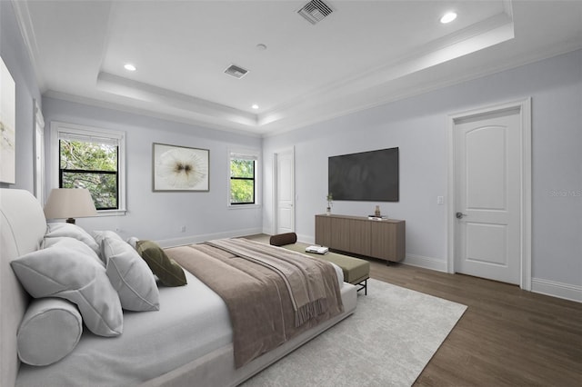 bedroom featuring multiple windows, crown molding, dark wood-type flooring, and a raised ceiling