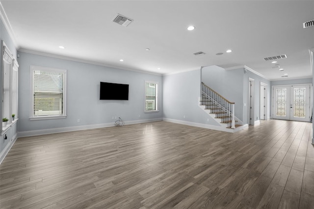 unfurnished living room with a healthy amount of sunlight and light hardwood / wood-style floors