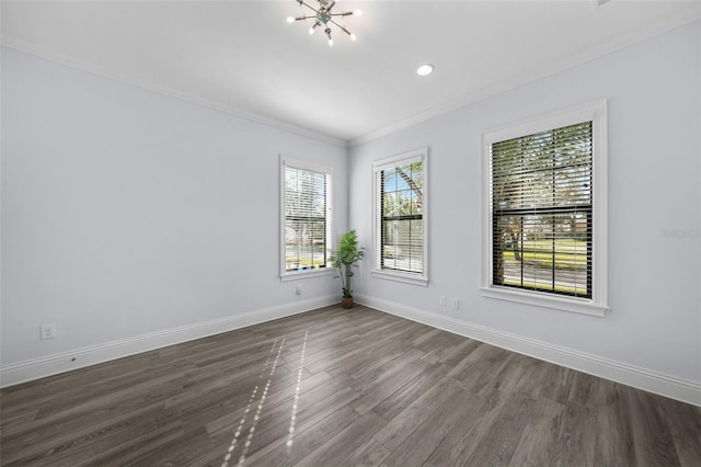 spare room featuring crown molding, a chandelier, and dark hardwood / wood-style flooring