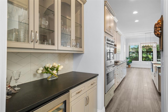 kitchen with hanging light fixtures, backsplash, cream cabinetry, dark hardwood / wood-style flooring, and beverage cooler