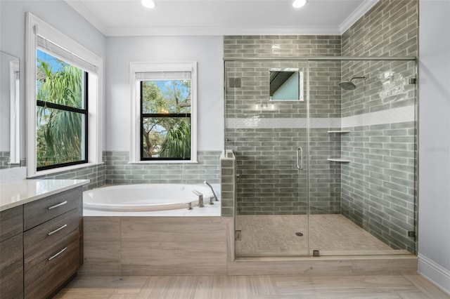 bathroom featuring crown molding, shower with separate bathtub, and vanity