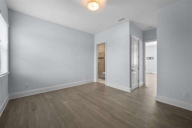 spare room with dark wood-type flooring