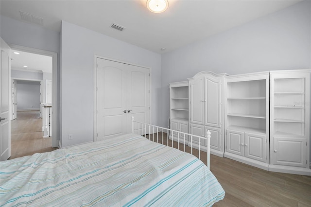 bedroom featuring wood-type flooring and a closet