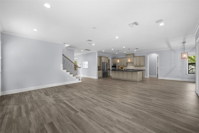 unfurnished living room with crown molding and dark wood-type flooring