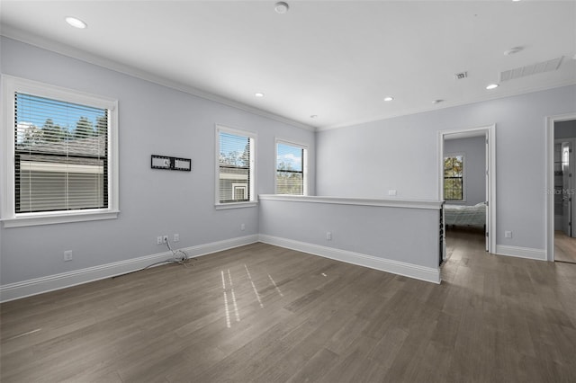 empty room with crown molding and dark wood-type flooring