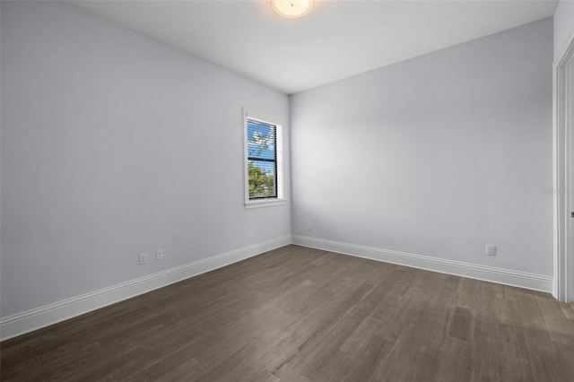 spare room featuring dark wood-type flooring