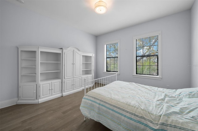 bedroom with dark wood-type flooring