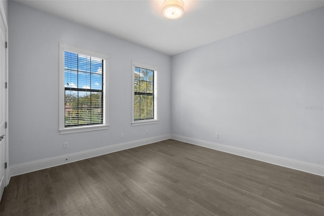 unfurnished room featuring dark wood-type flooring