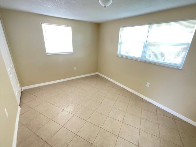 spare room with light tile patterned floors