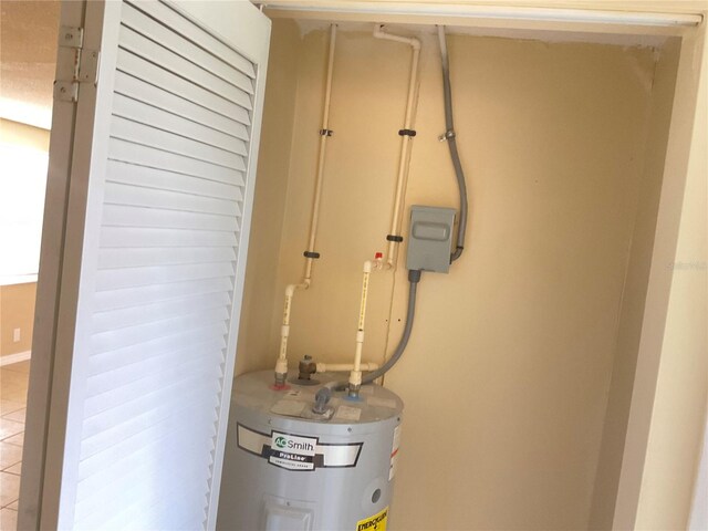 details featuring tile patterned flooring and electric water heater