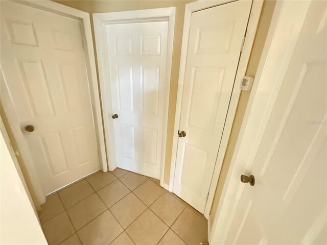 corridor featuring light tile patterned flooring